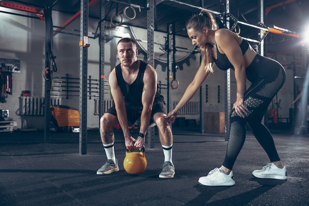 Uomo e donna atletici con le teste di legno