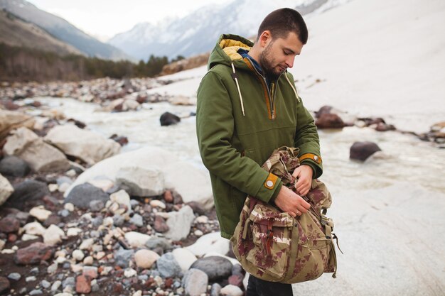 Uomo giovane hipster, natura selvaggia, vacanze invernali, escursionismo