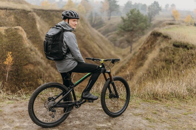 Uomo in sella a una bicicletta sul sentiero di montagna