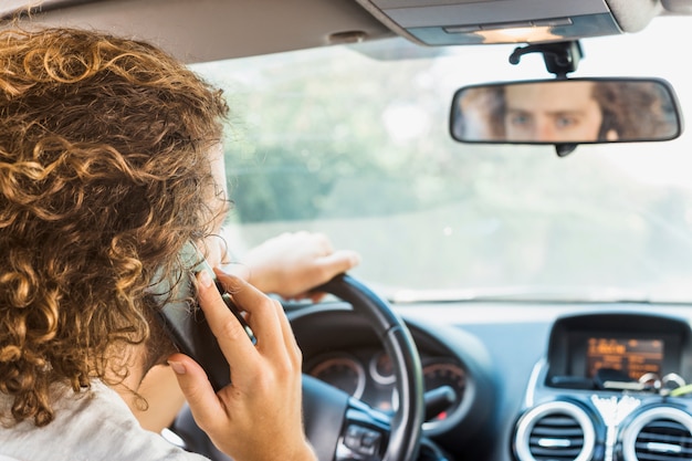 Uomo moderno che fa telefonata in macchina