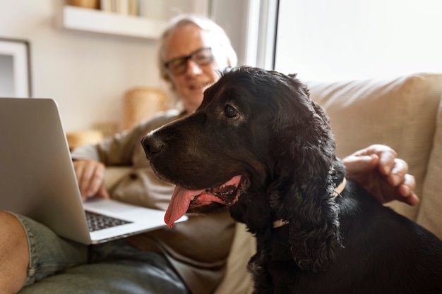 Uomo sorridente di vista laterale che accarezza il cane