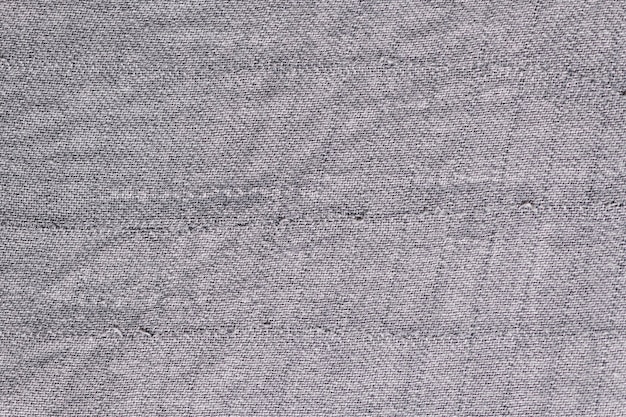 Vecchio fondo strutturato del tessuto grigio