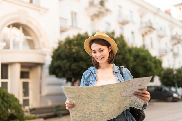 Viaggiatore con cappello che controlla la mappa locale