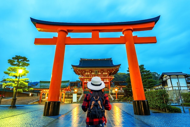 Viaggiatore della donna con lo zaino al santuario di fushimi inari taisha a Kyoto, Giappone.