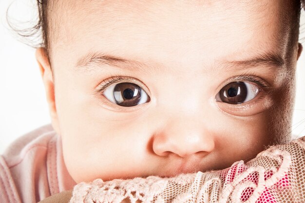 viso da bambino con occhi neri in camicia rosa