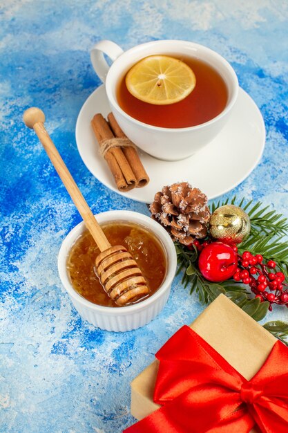 Vista dal basso tazza di tè miele regalo di Natale sul tavolo blu