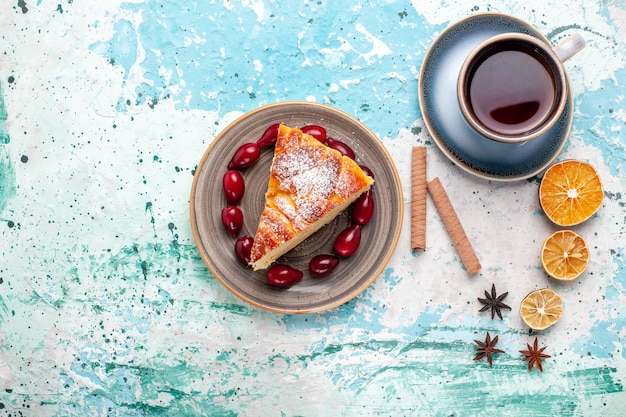 Vista dall'alto deliziosa fetta di torta con una tazza di tè sulla parete blu torta cuocere torta biscotto dolce