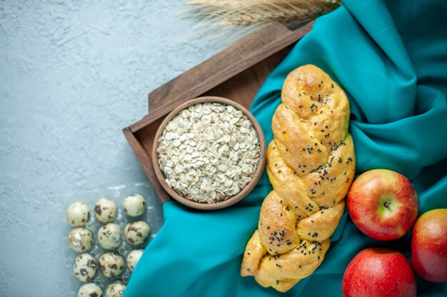 Vista dall'alto deliziosa pasticceria con mele rosse e fiori sulla superficie bianca torta dolce tè zucchero frutta biscotto biscotto torta dolce