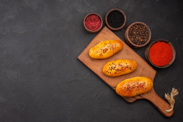 Vista dall'alto deliziose polpette al forno con diversi condimenti sullo sfondo scuro pasticceria cuocere la pasta al forno torta di carne torta