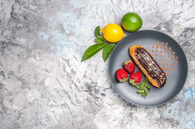 Vista dall'alto deliziosi bignè al cioccolato con fragole su un biscotto leggero da dessert