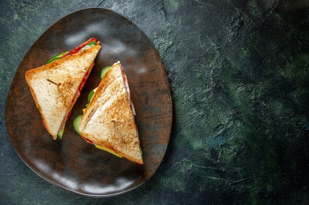 Vista dall'alto deliziosi panini al prosciutto all'interno della superficie scura del piatto