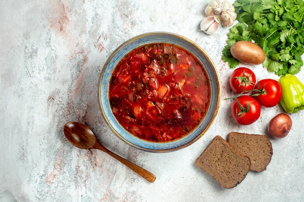 Vista dall'alto delizioso borsch con verdure e verdure fresche su uno spazio bianco