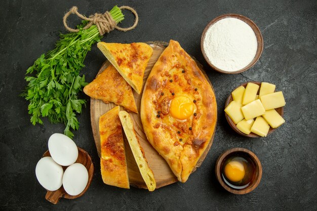 Vista dall'alto delizioso pane all'uovo cotto a fette con formaggio e farina sullo spazio grigio