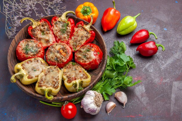 Vista dall'alto delizioso piatto di peperoni al forno con carne tritata e verdure su sfondo scuro cena cibo cuocere piatto di carne