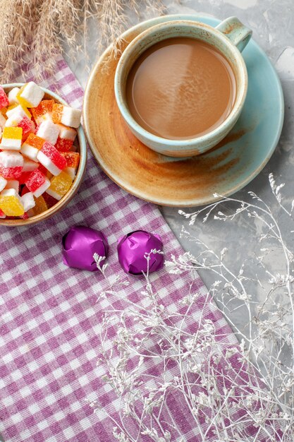 Vista dall'alto di caramelle con caffè sulla scrivania leggera, zucchero dolce caramelle bonbon