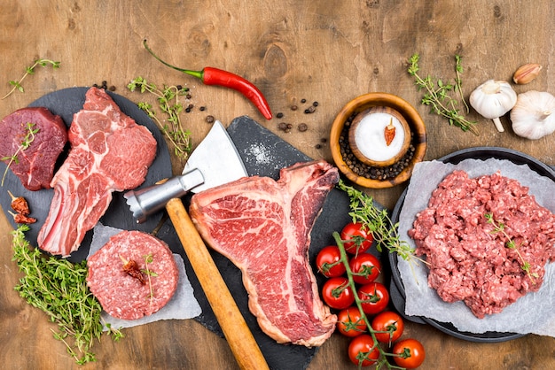 Vista dall'alto di carne con erbe e pomodori