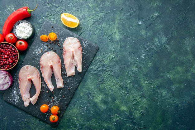 Vista dall'alto di fette di pesce fresco su sfondo scuro piatto insalata di frutti di mare carne di mare pepe di mare cibo acqua pasto