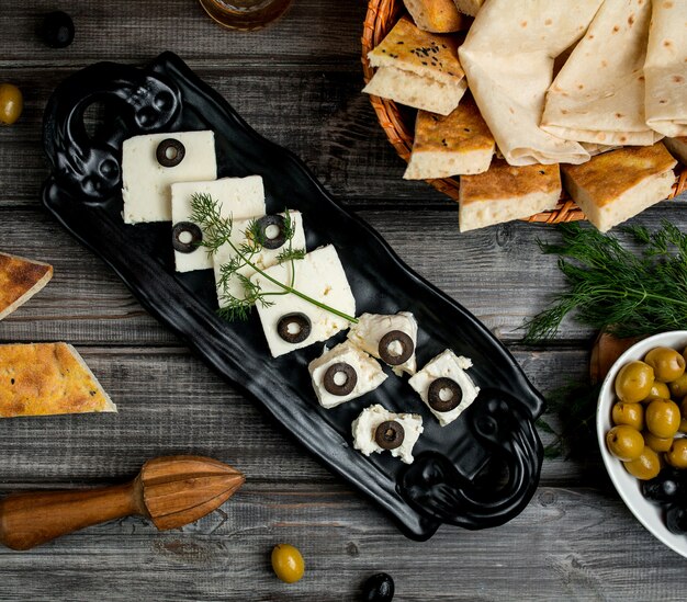 Vista dall'alto di formaggio bianco e di capra condita con fette di olive
