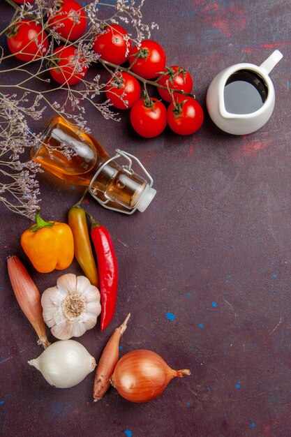 Vista dall'alto di verdure fresche con olio d'oliva sulla verdura cibo pasto piano scuro