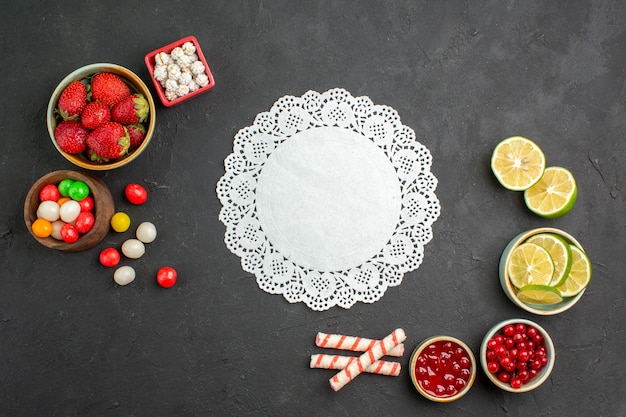 Vista dall'alto fette di limone con caramelle e frutta