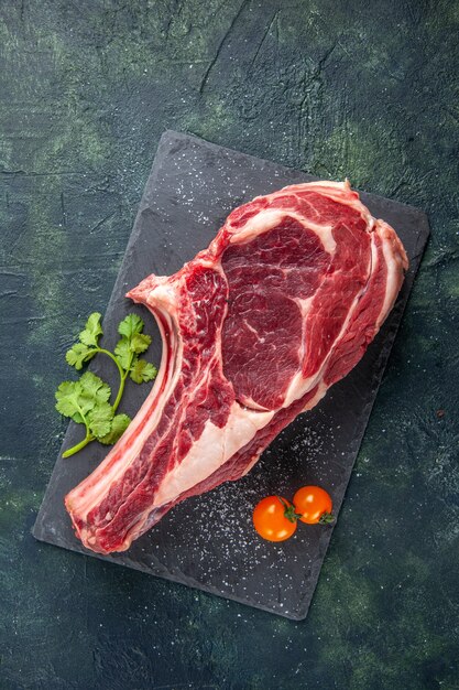 Vista dall'alto grande fetta di carne carne cruda su superficie scura