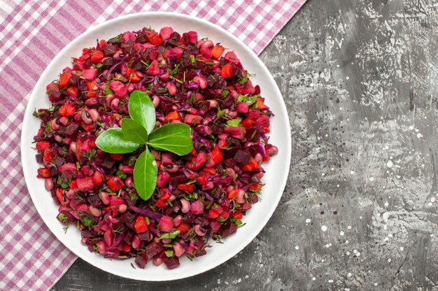 Vista dall'alto gustosa insalata di barbabietole vinaigrette all'interno del piatto sulla superficie scura