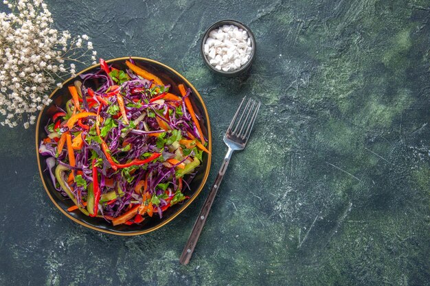 Vista dall'alto gustosa insalata di cavolo con peperoni all'interno della piastra su sfondo scuro salute pane spuntino pasto dieta pranzo vacanza cibo