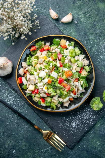 vista dall'alto gustosa insalata di verdure all'interno della piastra su sfondo blu scuro colore cucina pranzo salute alimentare dieta pasto