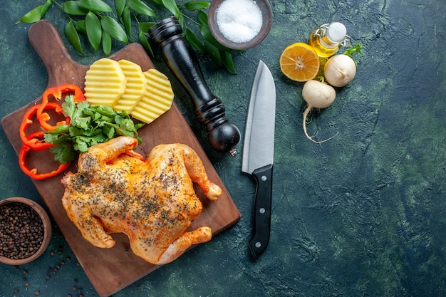 Vista dall'alto gustoso pollo cotto condito con patate su sfondo scuro colore carne piatto cena cibo ristorante barbecue