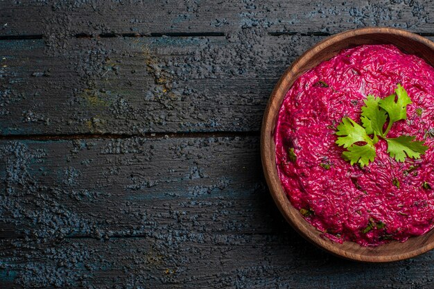 Vista dall'alto insalata di barbabietole con noci e maionese sulla scrivania scura