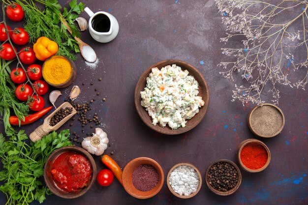 Vista dall'alto insalata di maionese con condimenti e verdure in uno spazio buio