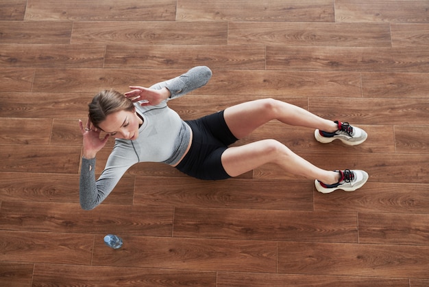 Vista dall'alto. La giovane donna allegra ha una giornata di fitness in palestra al mattino