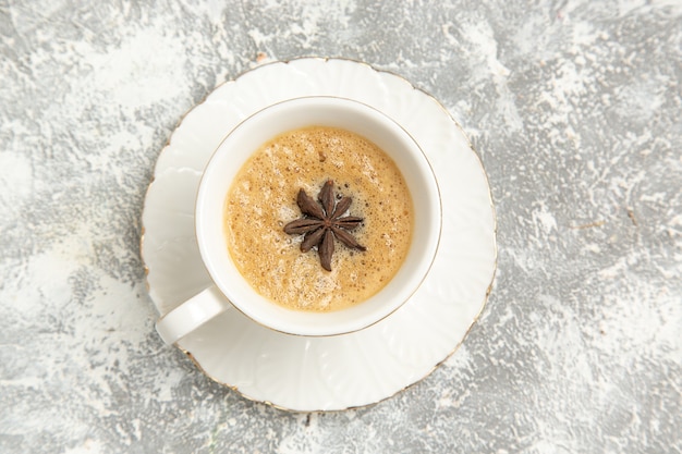 Vista dall'alto tazza di caffè delizioso cappuccino all'interno della tazza sulla superficie bianca