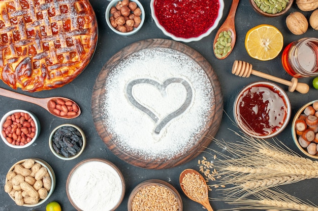 Vista dall'alto torta di frutta gustosa con noci di marmellata e farina su torta di biscotti al cioccolato fondente torta di tè dolce pasta per cuocere lo zucchero