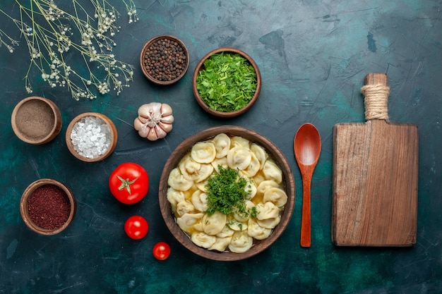 Vista dall'alto una deliziosa zuppa di gnocchi con diversi condimenti sulla superficie verde zuppa di carne di cibo vegetale di pasta