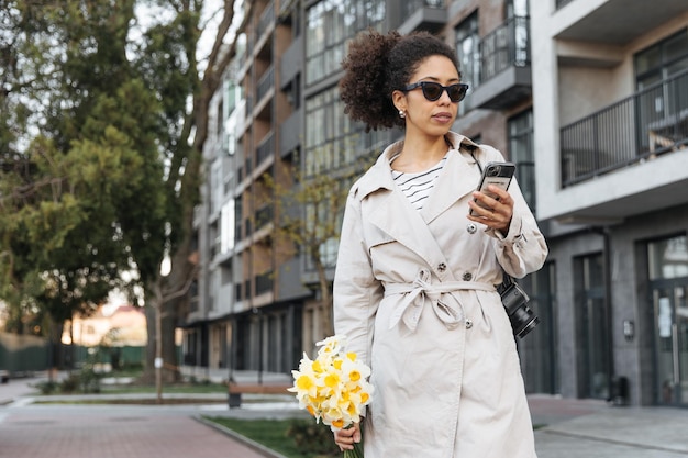 Vista della donna femmina nera guardando il telefono