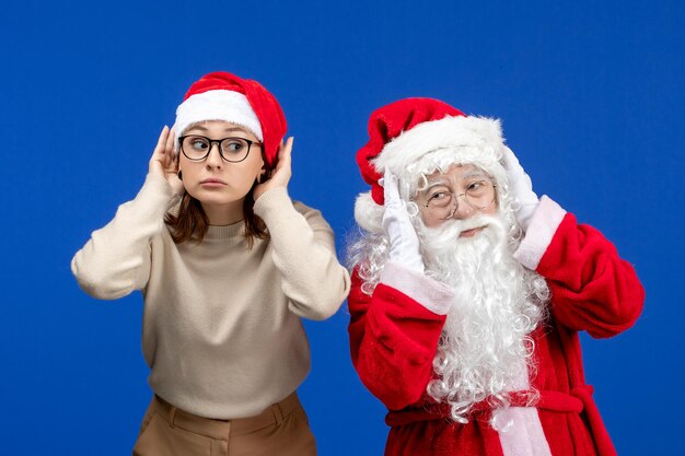 Vista frontale babbo natale con bella donna in piedi e in ascolto su colore blu neve natale capodanno emozione