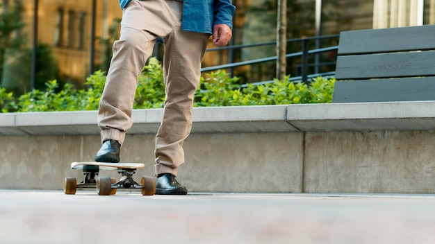 Vista frontale del vecchio con skateboard