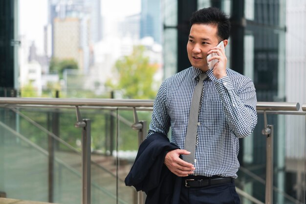 Vista frontale dell'uomo di affari che comunica sul telefono