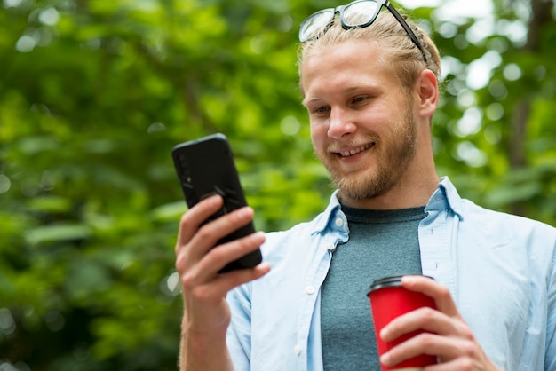 Vista frontale dell'uomo di smiley che parla sul telefono