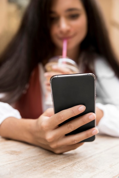 Vista frontale della donna con lo smartphone