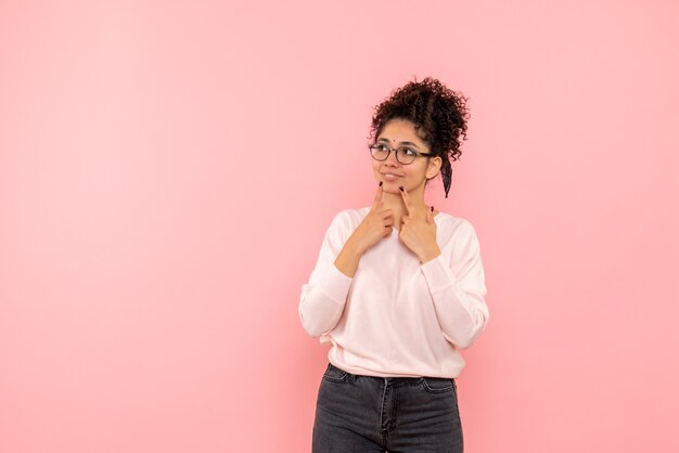 Vista frontale della donna graziosa che sogna sul rosa