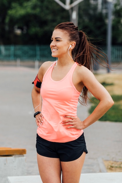 Vista frontale della donna in canottiera sportiva arancio