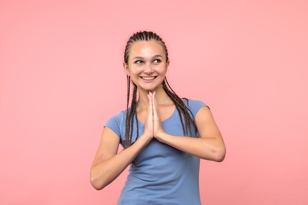 Vista frontale della giovane donna sorridente sul rosa