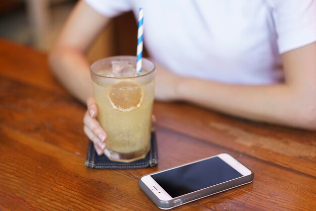 Vista frontale della ragazza giapponese carina che beve limonata