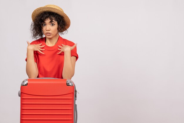 Vista frontale giovane donna con borsa rossa che si prepara per il viaggio su sfondo bianco viaggio colore aereo sole vacanza turistica