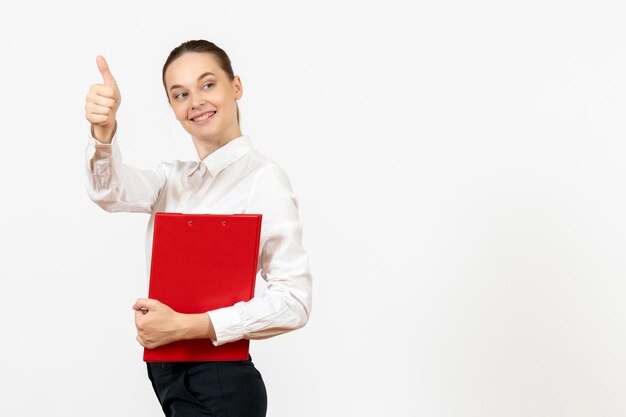 Vista frontale giovane donna in camicetta bianca con file rosso nelle sue mani su sfondo bianco lavoro d'ufficio emozioni femminili sentimento modello