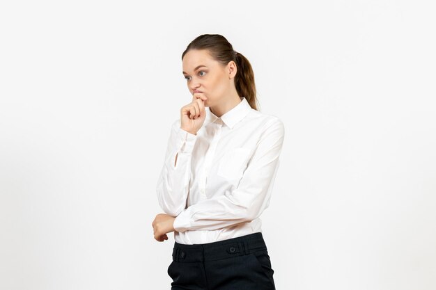 Vista frontale giovane donna in elegante camicetta bianca con faccia pensante su sfondo bianco donna lavoro d'ufficio signora lavoratrice