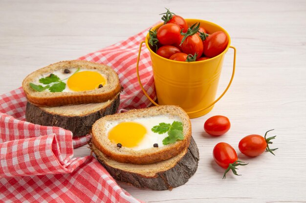 Vista frontale gustosi toast all'uovo con pomodori su sfondo bianco colazione insalata cibo foto pasto mattutino pranzo a colori