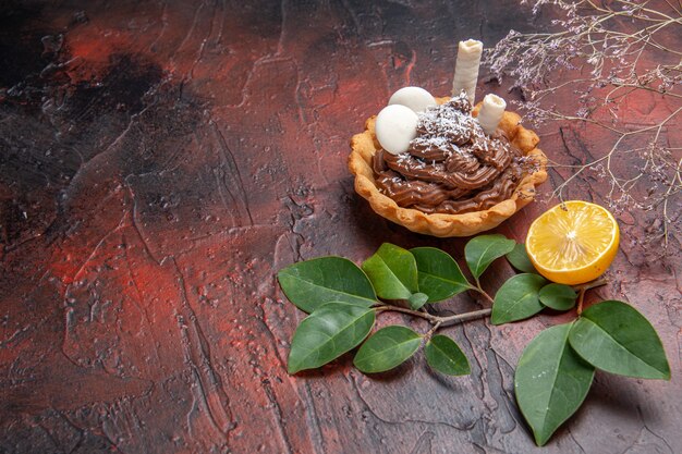 Vista frontale gustosissima torta cremosa sul dolce del dessert del biscotto della torta della tavola scura